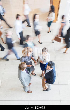 High angle view of Business people standing in office, talking and smiling Stock Photo