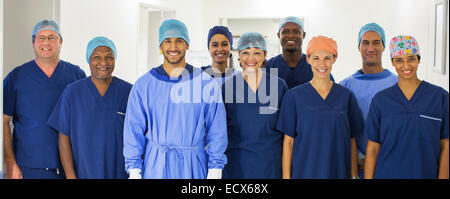 Group portrait of surgeons standing in hospital corridor