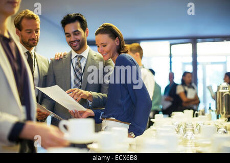 Portrait of businesspeople in lobby of conference center during coffee break Stock Photo