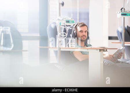 Portrait of man receiving intravenous infusion in hospital Stock Photo