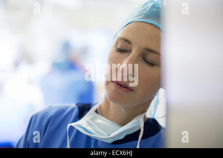 Female surgeon falling asleep in hospital Stock Photo
