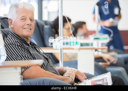Smiling man undergoing medical treatment in outpatient clinic Stock Photo