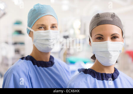 Portrait of female doctors wearing scrubs in operating theater Stock Photo