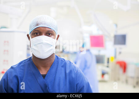 Portrait of surgeon wearing surgical mask and cap in operating theater Stock Photo