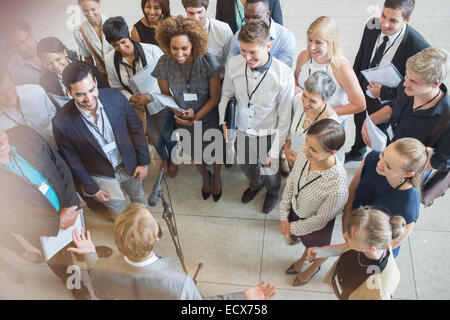 High angle view of business people looking at colleague giving speech Stock Photo