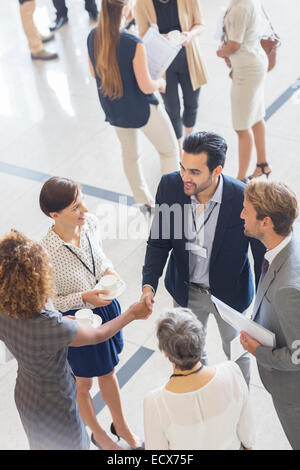 High angle view of group of business people shaking hands in office Stock Photo