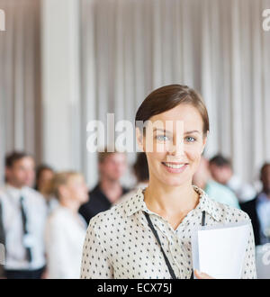 Portrait of businesswoman in office with document in hand Stock Photo