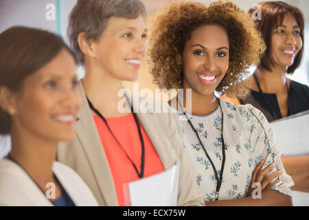 Portrait of businesswoman, looking at camera and standing with her colleagues Stock Photo
