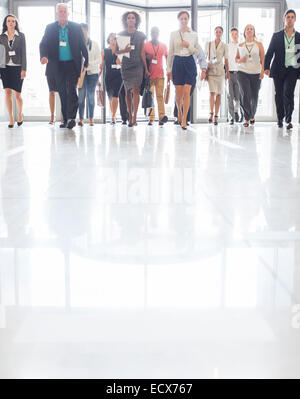 Large group of business people walking in office Stock Photo