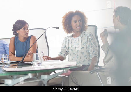 Portrait of three women having discussion at conference table Stock Photo