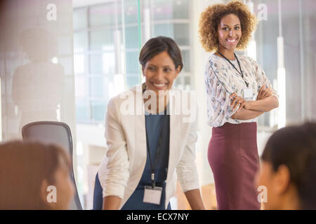 Two women standing in conference room Stock Photo