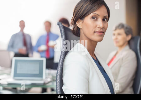 Portrait of beautiful businesswoman sitting in office Stock Photo