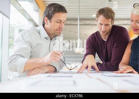 Business people reading paperwork in office meeting Stock Photo