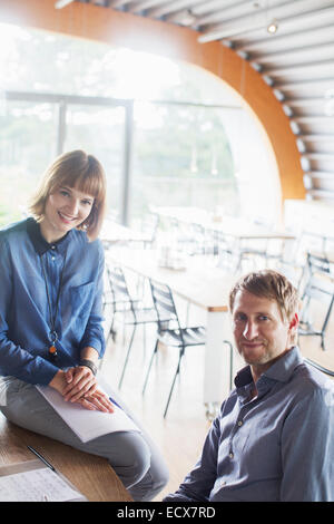 Business people smiling in cafeteria Stock Photo