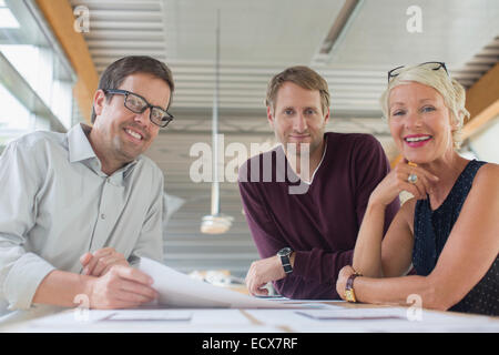 Business people smiling in office meeting Stock Photo