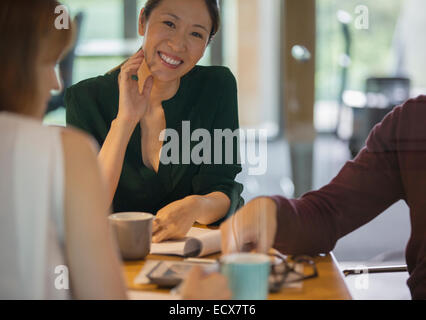 Businesswomen smiling in office meeting Stock Photo