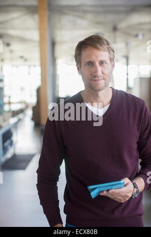 Businessman holding digital tablet in office Stock Photo