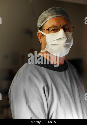 Portrait of mature surgeon by operating theater Stock Photo