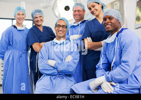 Group portrait of surgeons posing in operating theater Stock Photo