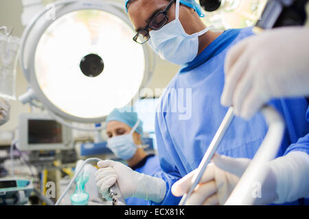 Doctor performing surgery in operating theater Stock Photo