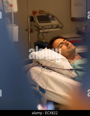 Male patient sleeping in hospital bed Stock Photo