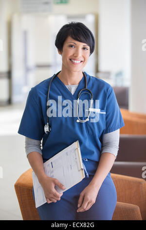 Portrait of female doctor holding clipboard in hospital Stock Photo