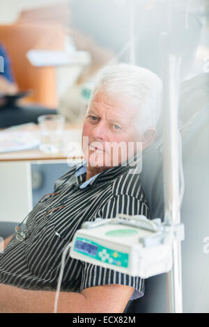 Senior man receiving intravenous infusion in hospital Stock Photo