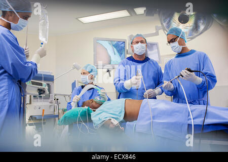 Team of surgeons operating on patient in hospital Stock Photo