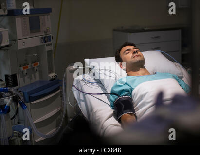 Male patient lying in hospital bed in intensive care unit Stock Photo