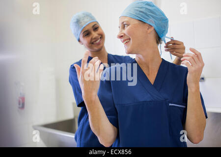 Two smiling surgeons getting ready for surgery Stock Photo