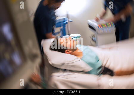 Blurred motion view of patient lying in bed in intensive care unit Stock Photo
