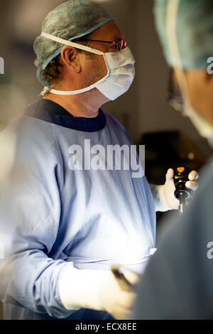 Doctor performing laparoscopic surgery in operating theater Stock Photo