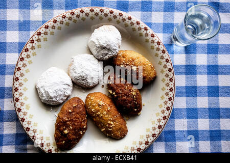 Traditional Greek Christmas Bisquits Melomakarona, Kourabiedes and glass of Raki, Tsikoudia Stock Photo