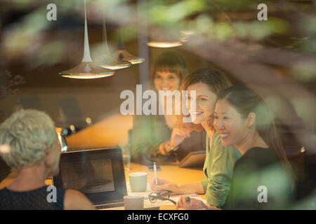 Businesswomen talking in office meeting Stock Photo