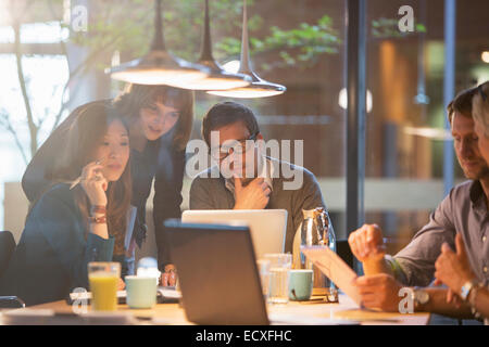 Business people using laptop in office meeting Stock Photo