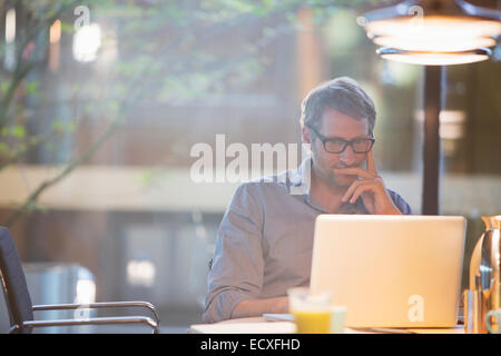 Businessman working on laptop in office Stock Photo