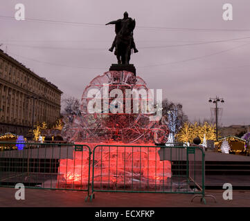 MOSCOW - DECEMBER 26, 2013: ice clock - decoration for Christmas and New Year holidays on Tverskaya street and monument of king Stock Photo