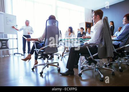 Business people having meeting in conference room, watching colleagues presentation Stock Photo
