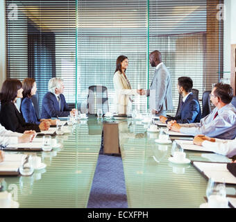 Business people shaking hands in conference room during business meeting Stock Photo