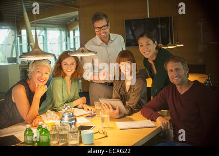 Business people smiling in office meeting Stock Photo