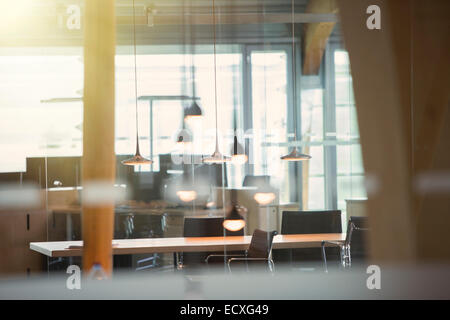 Light fixtures and desks in empty office Stock Photo