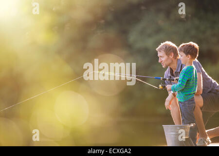 Father and son fishing in lake Stock Photo