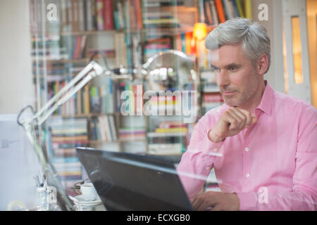 Businessman working on laptop in home office Stock Photo