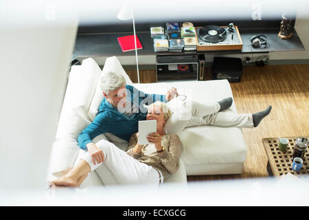 High angle view of older couple using digital tablet on sofa Stock Photo
