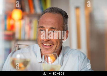 Older man drinking white wine Stock Photo