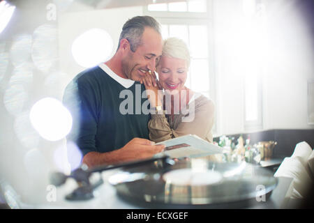 Older couple listening to vinyl records Stock Photo