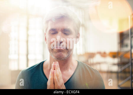 Close up of older man meditating Stock Photo
