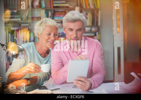 Business people using digital tablet in home office Stock Photo