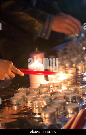 Trafalgar Square, London, UK. 21st Dec 2014. Members of the Pakistani community light candles in memory of those killed by the Taliban in the Peshawar school attack. Credit:  Matthew Chattle/Alamy Live News Stock Photo