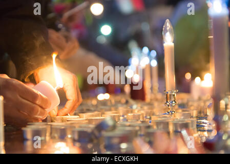 Trafalgar Square, London, UK. 21st Dec 2014. Members of the Pakistani community light candles in memory of those killed by the Taliban in the Peshawar school attack. Credit:  Matthew Chattle/Alamy Live News Stock Photo